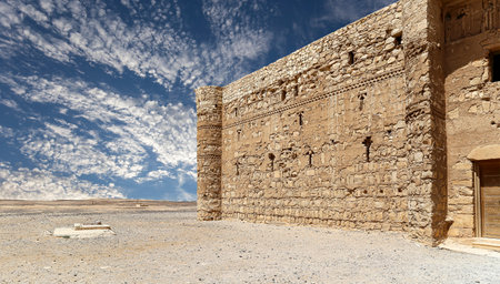 Qasr Kharana (Kharanah or Harrana)-- desert castle in eastern Jordan (100 km of Amman). Built in 8th century AD to be used as caravanserai, a resting place for traders. Against the sky with cloudsの写真素材