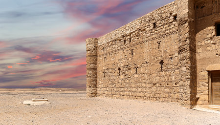 Qasr Kharana (Kharanah or Harrana)-- desert castle in eastern Jordan (100 km of Amman). Built in 8th century AD to be used as caravanserai, a resting place for traders. Against the sky with cloudsの写真素材