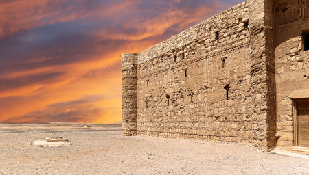 Qasr Kharana (Kharanah or Harrana)-- desert castle in eastern Jordan (100 km of Amman). Built in 8th century AD to be used as caravanserai, a resting place for traders. Against the sky with cloudsの写真素材