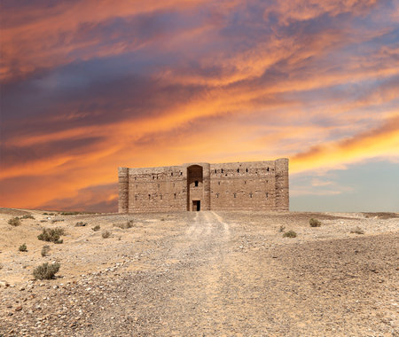 Qasr Kharana (Kharanah or Harrana)-- desert castle in eastern Jordan (100 km of Amman). Built in 8th century AD to be used as caravanserai, a resting place for traders. Against the sky with cloudsの写真素材