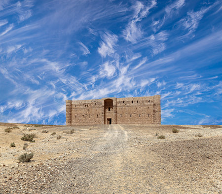 Qasr Kharana (Kharanah or Harrana)-- desert castle in eastern Jordan (100 km of Amman). Built in 8th century AD to be used as caravanserai, a resting place for traders. Against the sky with cloudsの写真素材