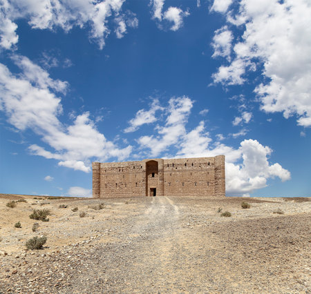Qasr Kharana (Kharanah or Harrana)-- desert castle in eastern Jordan (100 km of Amman). Built in 8th century AD to be used as caravanserai, a resting place for traders. Against the sky with cloudsの写真素材