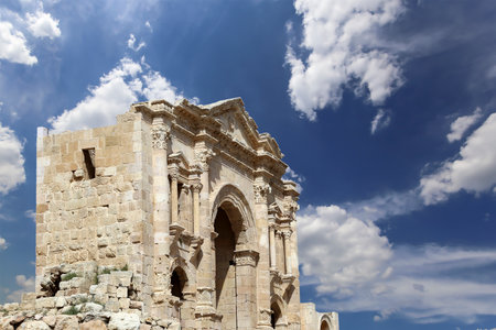 Arch of Hadrian in Gerasa (Jerash)-- was built to honor the visit of emperor Hadrian to Jerash in 129/130 AD, Jordan. Against the background of a beautiful sky with cloudsの写真素材
