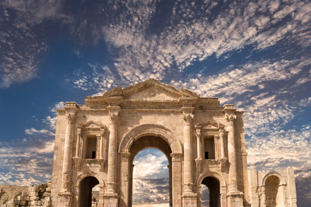 Arch of Hadrian in Gerasa (Jerash)-- was built to honor the visit of emperor Hadrian to Jerash in 129/130 AD, Jordan. Against the background of a beautiful sky with cloudsの写真素材