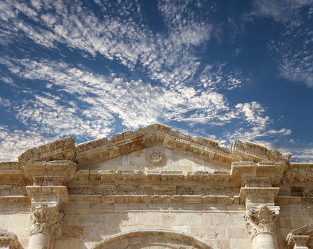 Arch of Hadrian in Gerasa (Jerash)-- was built to honor the visit of emperor Hadrian to Jerash in 129/130 AD, Jordan. Against the background of a beautiful sky with cloudsの写真素材