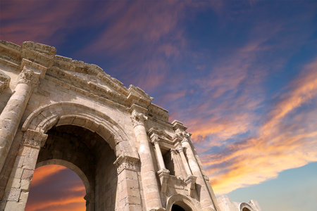 Arch of Hadrian in Gerasa (Jerash)-- was built to honor the visit of emperor Hadrian to Jerash in 129/130 AD, Jordan. Against the background of a beautiful sky with cloudsの写真素材