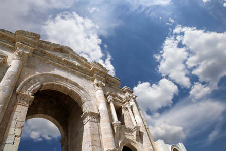 Arch of Hadrian in Gerasa (Jerash)-- was built to honor the visit of emperor Hadrian to Jerash in 129/130 AD, Jordan. Against the background of a beautiful sky with cloudsの写真素材