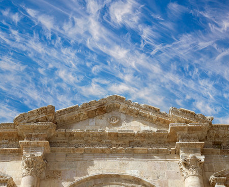 Arch of Hadrian in Gerasa (Jerash)-- was built to honor the visit of emperor Hadrian to Jerash in 129/130 AD, Jordan. Against the background of a beautiful sky with cloudsの写真素材