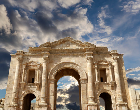 Arch of Hadrian in Gerasa (Jerash)-- was built to honor the visit of emperor Hadrian to Jerash in 129/130 AD, Jordan. Against the background of a beautiful sky with cloudsの写真素材