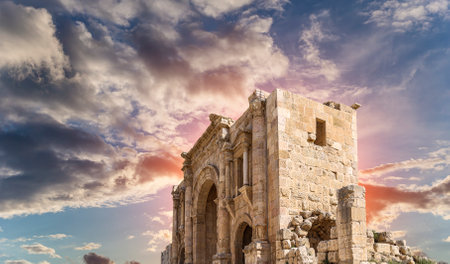 Arch of Hadrian in Gerasa (Jerash)-- was built to honor the visit of emperor Hadrian to Jerash in 129/130 AD, Jordan. Against the background of a beautiful sky with cloudsの写真素材
