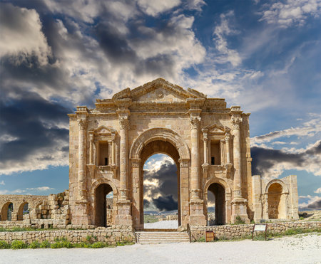 Arch of Hadrian in Gerasa (Jerash)-- was built to honor the visit of emperor Hadrian to Jerash in 129/130 AD, Jordan. Against the background of a beautiful sky with cloudsの写真素材