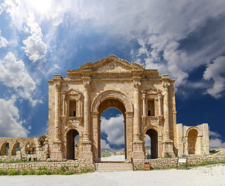 Arch of Hadrian in Gerasa (Jerash)-- was built to honor the visit of emperor Hadrian to Jerash in 129/130 AD, Jordan. Against the background of a beautiful sky with cloudsの写真素材