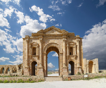Arch of Hadrian in Gerasa (Jerash)-- was built to honor the visit of emperor Hadrian to Jerash in 129/130 AD, Jordan. Against the background of a beautiful sky with cloudsの写真素材