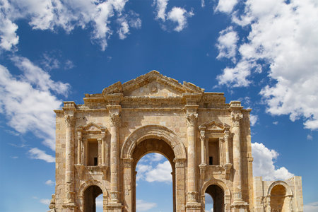 Arch of Hadrian in Gerasa (Jerash)-- was built to honor the visit of emperor Hadrian to Jerash in 129/130 AD, Jordan. Against the background of a beautiful sky with cloudsの写真素材