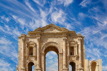 Arch of Hadrian in Gerasa (Jerash)-- was built to honor the visit of emperor Hadrian to Jerash in 129/130 AD, Jordan. Against the background of a beautiful sky with cloudsの写真素材