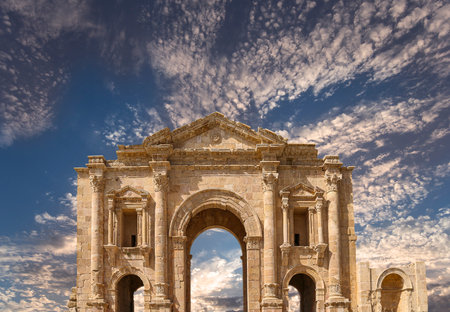 Arch of Hadrian in Gerasa (Jerash)-- was built to honor the visit of emperor Hadrian to Jerash in 129/130 AD, Jordan. Against the background of a beautiful sky with cloudsの写真素材