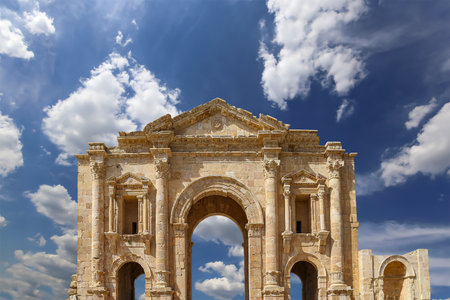 Arch of Hadrian in Gerasa (Jerash)-- was built to honor the visit of emperor Hadrian to Jerash in 129/130 AD, Jordan. Against the background of a beautiful sky with cloudsの写真素材