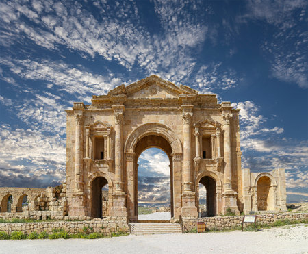 Arch of Hadrian in Gerasa (Jerash)-- was built to honor the visit of emperor Hadrian to Jerash in 129/130 AD, Jordan. Against the background of a beautiful sky with cloudsの写真素材