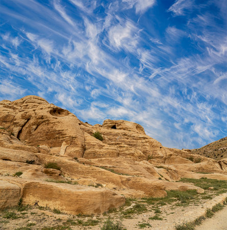 Mountains of Petra (against the background of a beautiful sky with clouds), Jordan, Middle East. Petra has been a UNESCO World Heritage Site since 1985の写真素材