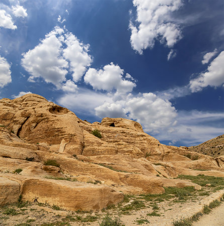 Mountains of Petra (against the background of a beautiful sky with clouds), Jordan, Middle East. Petra has been a UNESCO World Heritage Site since 1985の写真素材