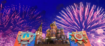 Cathedral of Intercession of Most Holy Theotokos on the Moat (Temple of Basil the Blessed) with orders of victory, and fireworks in honor of Victory Day celebration (WWII), Red Square, Moscow, Russiaの写真素材