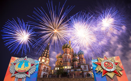 Cathedral of Intercession of Most Holy Theotokos on the Moat (Temple of Basil the Blessed) with orders of victory, and fireworks in honor of Victory Day celebration (WWII), Red Square, Moscow, Russiaの写真素材