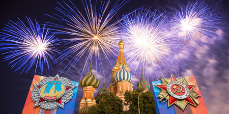 Cathedral of Intercession of Most Holy Theotokos on the Moat (Temple of Basil the Blessed) with orders of victory, and fireworks in honor of Victory Day celebration (WWII), Red Square, Moscow, Russiaの写真素材