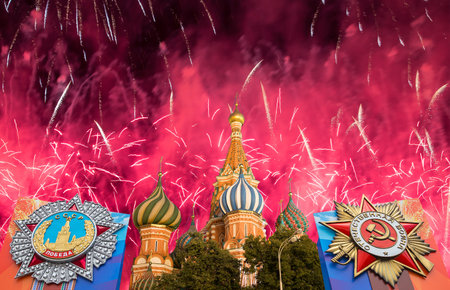 Cathedral of Intercession of Most Holy Theotokos on the Moat (Temple of Basil the Blessed) with orders of victory, and fireworks in honor of Victory Day celebration (WWII), Red Square, Moscow, Russiaの写真素材