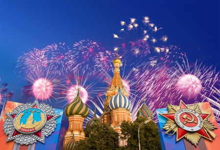 Cathedral of Intercession of Most Holy Theotokos on the Moat (Temple of Basil the Blessed) with orders of victory, and fireworks in honor of Victory Day celebration (WWII), Red Square, Moscow, Russiaの写真素材