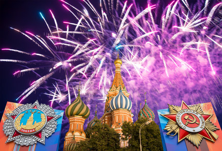 Cathedral of Intercession of Most Holy Theotokos on the Moat (Temple of Basil the Blessed) with orders of victory, and fireworks in honor of Victory Day celebration (WWII), Red Square, Moscow, Russiaの写真素材