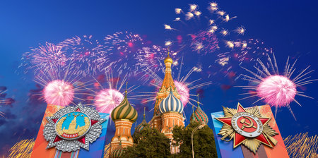 Cathedral of Intercession of Most Holy Theotokos on the Moat (Temple of Basil the Blessed) with orders of victory, and fireworks in honor of Victory Day celebration (WWII), Red Square, Moscow, Russiaの写真素材
