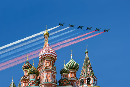 Temple of Basil the Blessed and Russian military aircraft with painted Russian flag in the sky, Air...