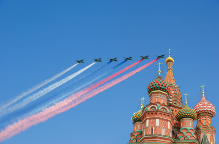 Temple of Basil the Blessed and Russian military aircraft with painted Russian flag in the sky, Air...