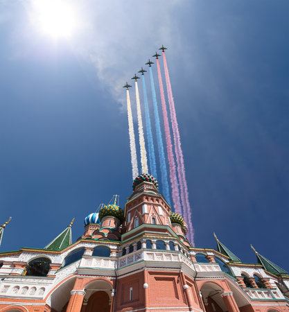 Temple of Basil the Blessed and Russian military aircraft with painted Russian flag in the sky, Air parade in honor of Victory Day celebration (WWII), Red Square, Moscow, Russiaの写真素材