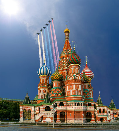 Temple of Basil the Blessed and Russian military aircraft with painted Russian flag in the sky, Air...