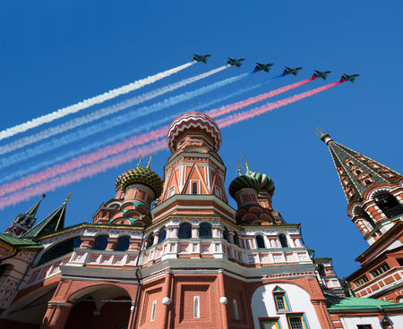 Temple of Basil the Blessed and Russian military aircraft with painted Russian flag in the sky, Air...