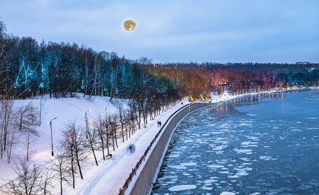 Christmas (New Year holidays) decoration in Moscow (at night, with the super moon), Russia-- Vorobyovskaya Embankment of the Moscow river and Sparrow Hills (Vorobyovy Gory)の写真素材