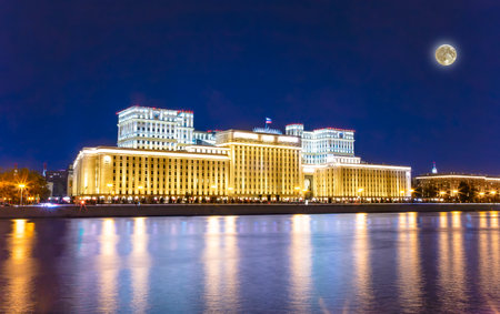 Main Building of the Ministry of Defense of the Russian Federation (Minoboron) -- inscription in Russian, at night (with the super moon) and Moskva River. Moscow, Russiaの写真素材