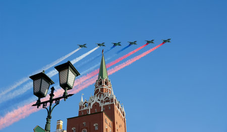 Moscow Kremlin, Russia -- Victory Day celebration (WWII), and Russian military aircraft with painted Russian flag, Russiaの写真素材