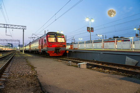 Train on Moscow passenger platform (Savelovsky railway station) with the super moon -- is one of the...