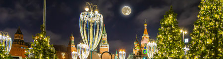 Saint Basil cathedral (Temple of Basil the Blessed), Spasskaya Tower and Christmas (New Year) decoration (at night with the super moon), Moscow, Russia. View from Zaryadye Park. Journey to Christmasの写真素材