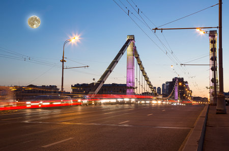 Krymsky Bridge or Crimean Bridge (night, with the super moon) is a steel suspension bridge in Moscow, Russia. The bridge spans the Moskva River 1,800 meters south-west from the Kremlinの写真素材