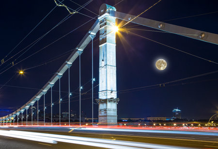 Krymsky Bridge or Crimean Bridge (night, with the super moon) is a steel suspension bridge in Moscow, Russia. The bridge spans the Moskva River 1,800 meters south-west from the Kremlinの写真素材