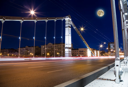 Krymsky Bridge or Crimean Bridge (night, with the super moon) is a steel suspension bridge in Moscow, Russia. The bridge spans the Moskva River 1,800 meters south-west from the Kremlinの写真素材