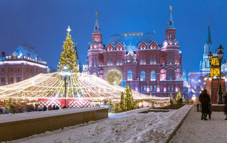 Christmas (New Year holidays) illumination and State Historical Museum (It is written in Russian) at night (with the super moon), near the Kremlin in Moscow, Russiaの写真素材