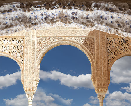 Arches in Islam (Moorish) style (against the background of a beautiful sky with clouds) in Alhambra, Granada, Spainの写真素材