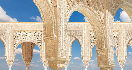 Arches in Islam (Moorish) style (against the background of a beautiful sky with clouds) in Alhambra,...