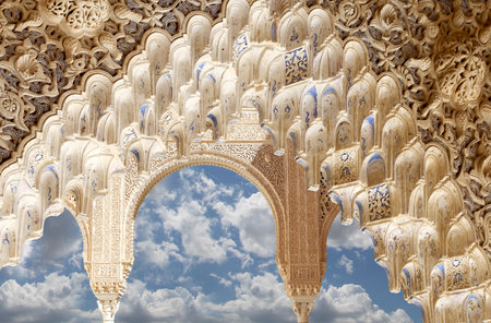 Arches in Islam (Moorish) style (against the background of a beautiful sky with clouds) in Alhambra, Granada, Spainの写真素材