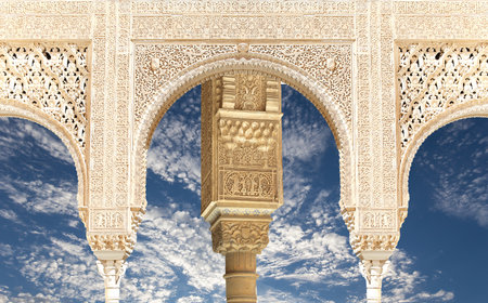 Arches in Islam (Moorish) style (against the background of a beautiful sky with clouds) in Alhambra, Granada, Spainの写真素材