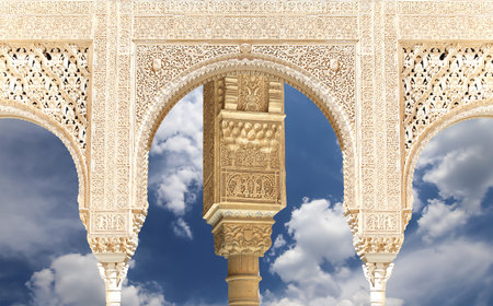 Arches in Islam (Moorish) style (against the background of a beautiful sky with clouds) in Alhambra, Granada, Spainの写真素材